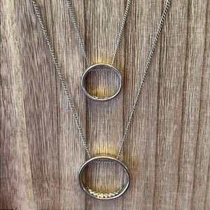 Long necklace accented with hoops and gemstones.